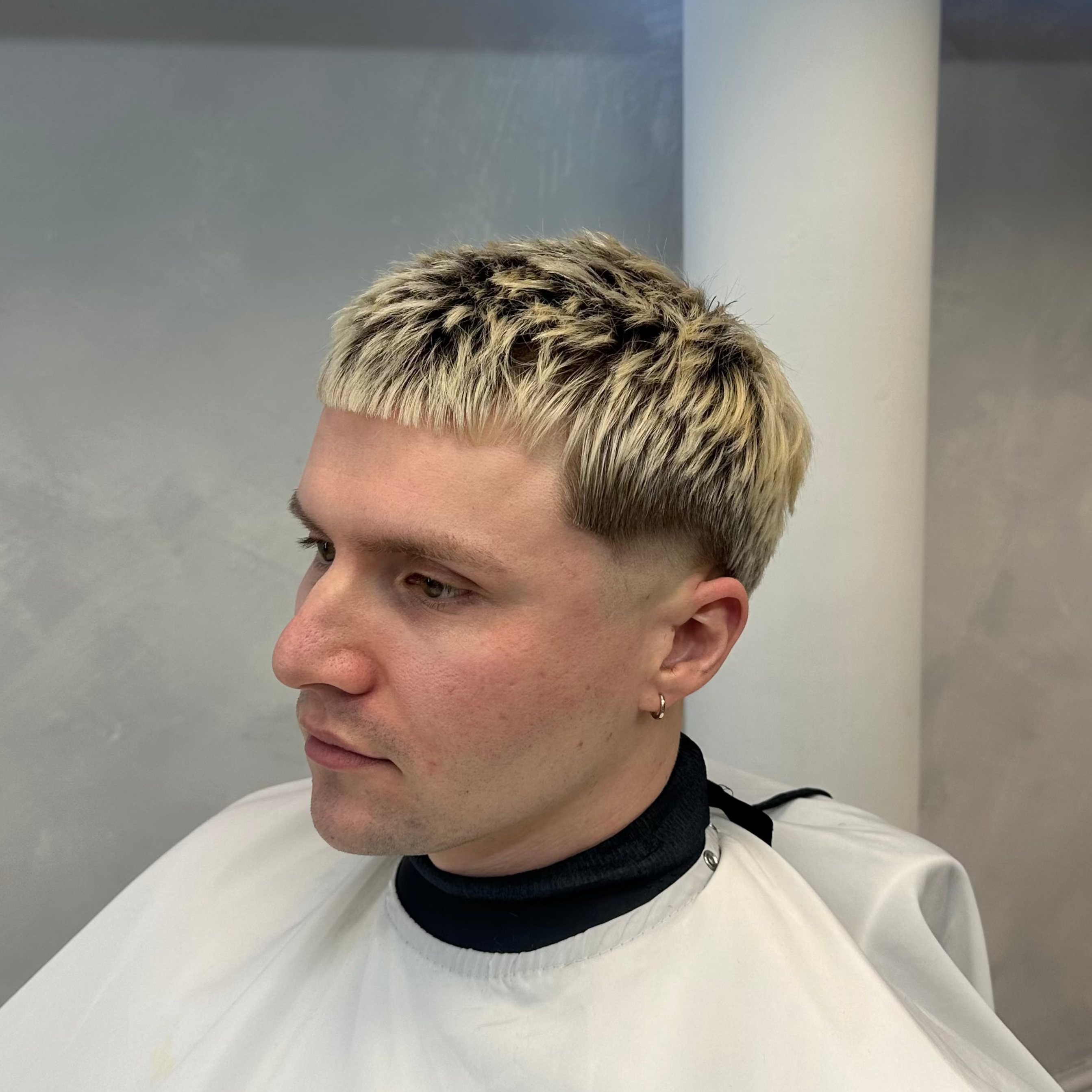 Person with a stylish haircut in a salon setting