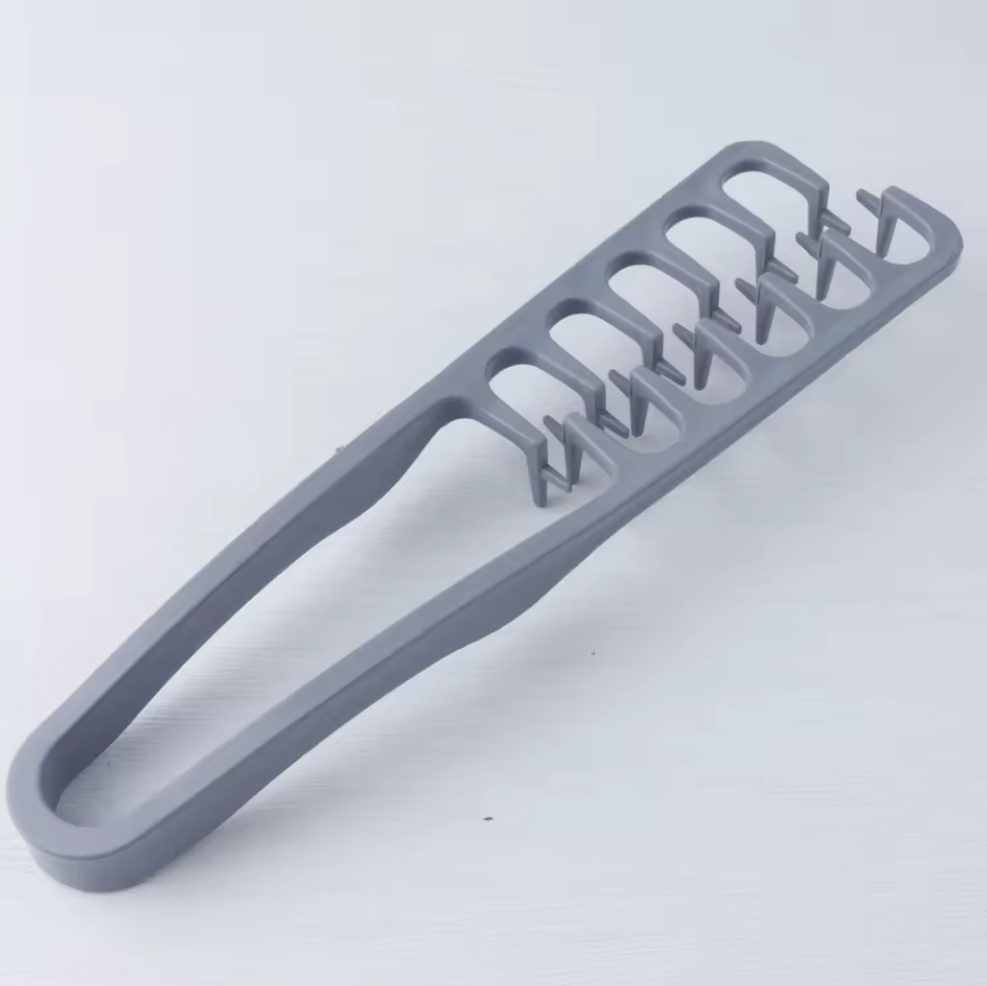 Gray plastic tool with multiple slots on a white background