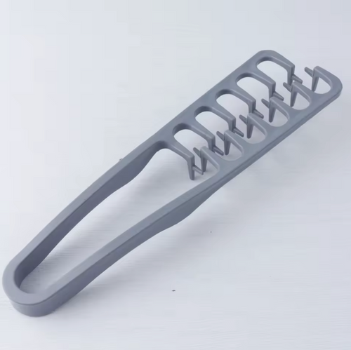 Gray plastic tool with multiple slots on a white background